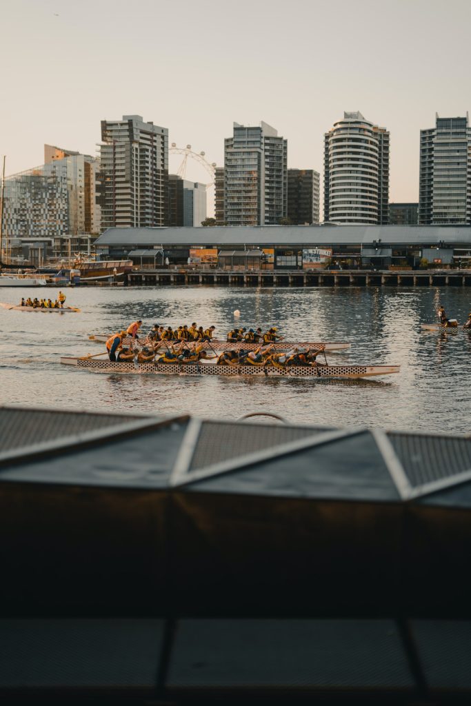 Team of rowers in urban waterway