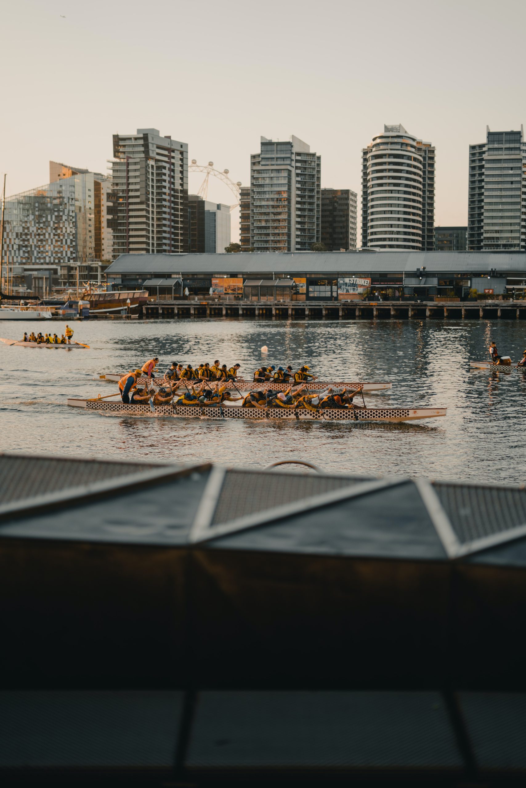 Team of rowers in urban waterway