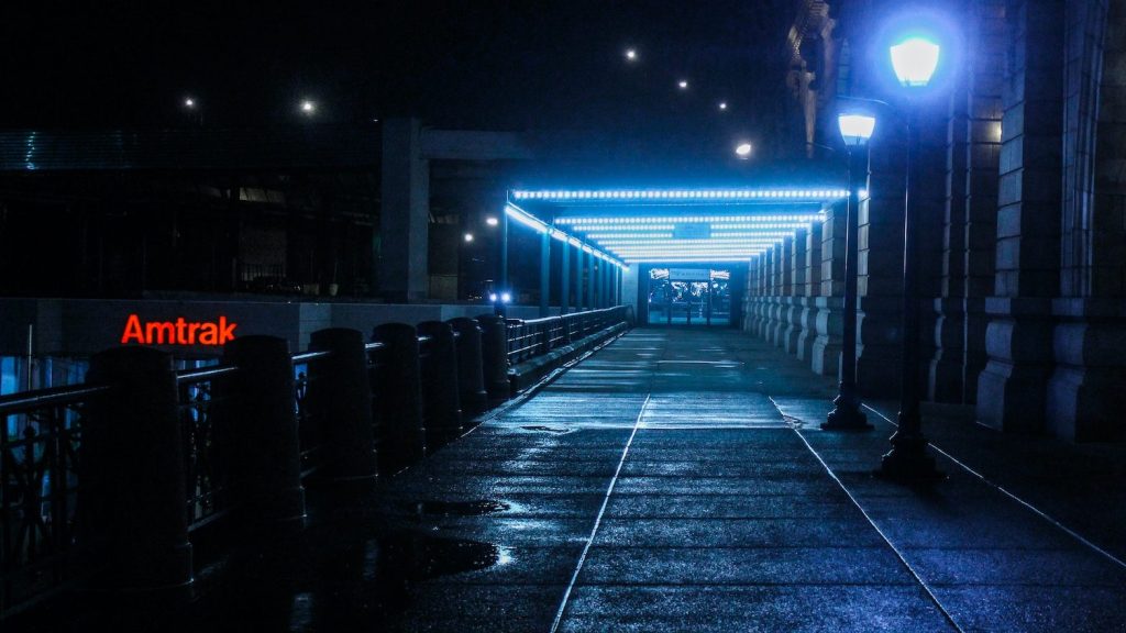 Lighted pathway in city at night.