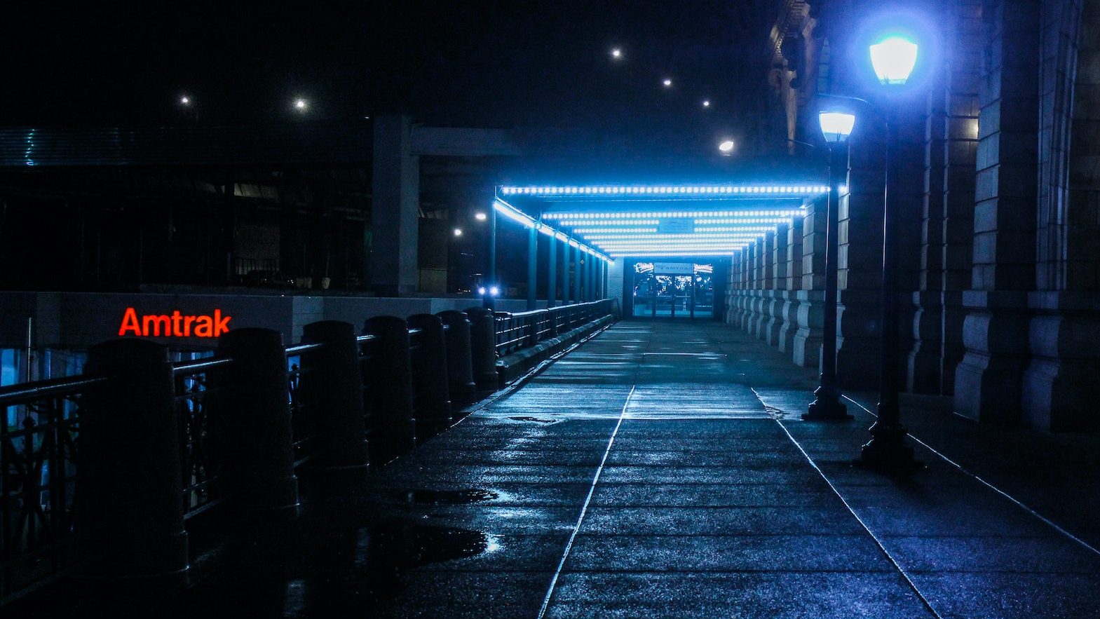 Lighted pathway in city at night.