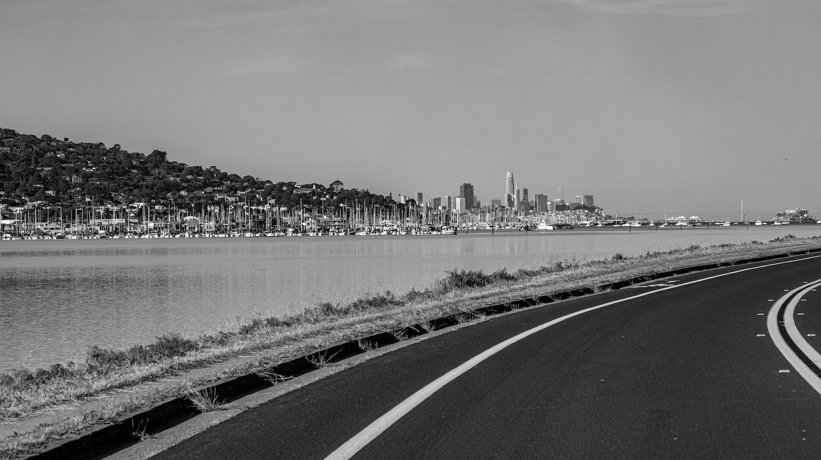 Road veering right with city in distant background
