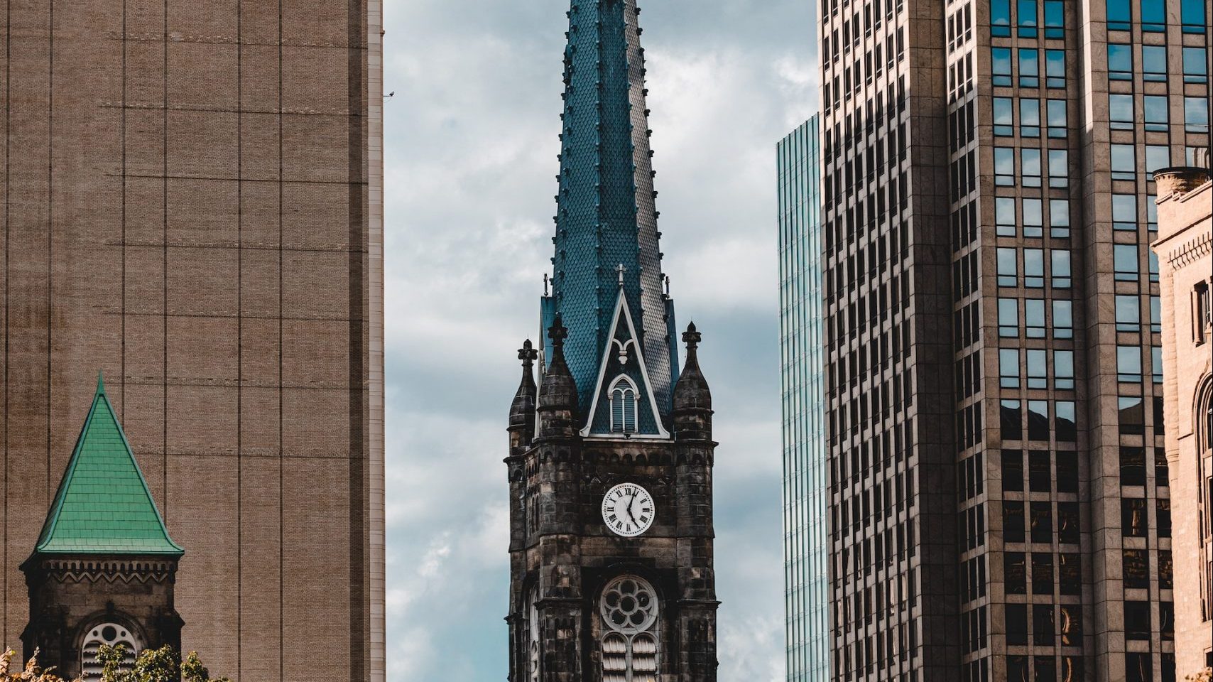 Steeple between skyscrapers