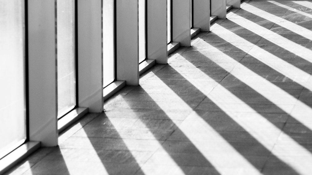 shadow angled on the ground from a set of windows